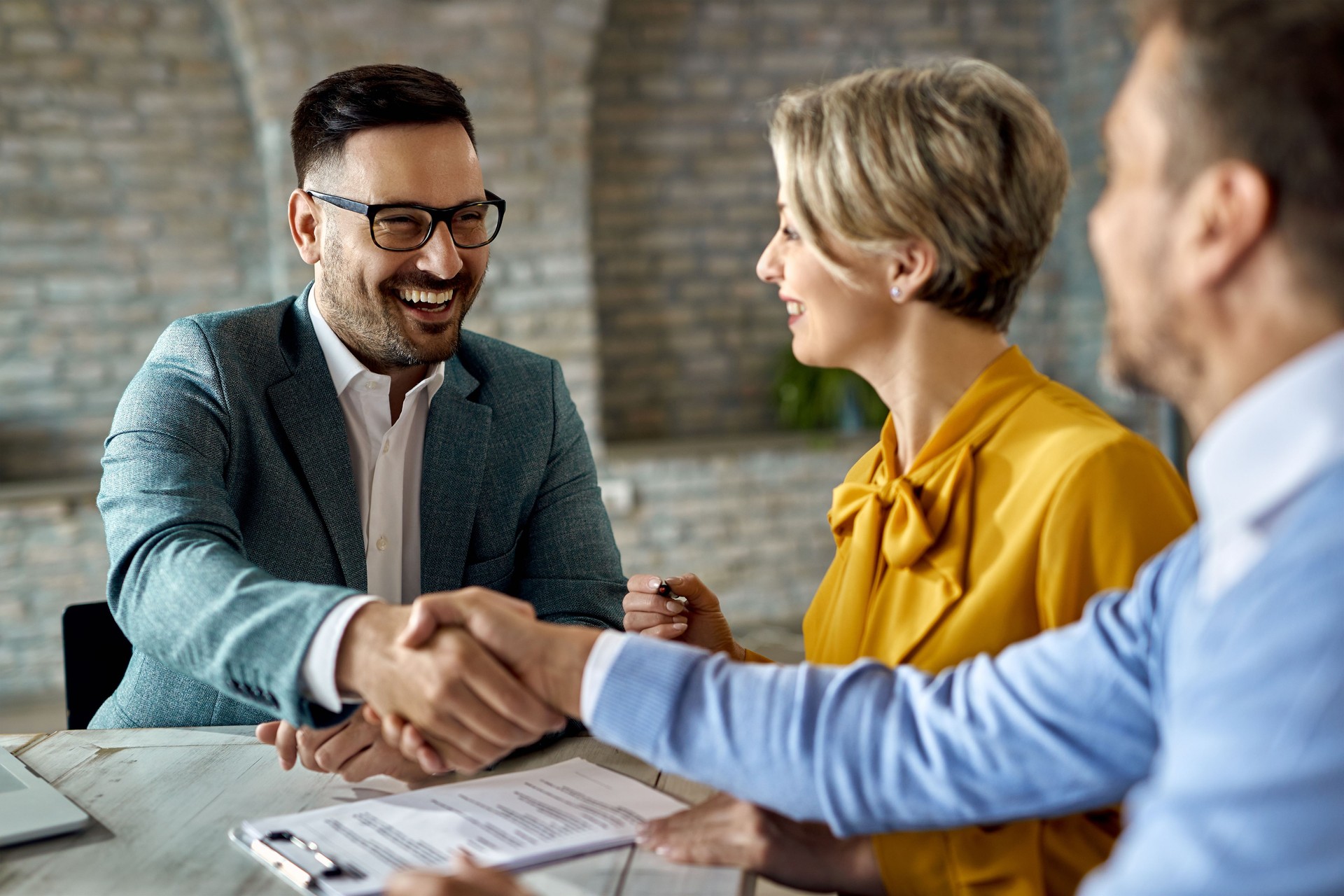 Happy insurance agent came to an agreement with a couple in the office.